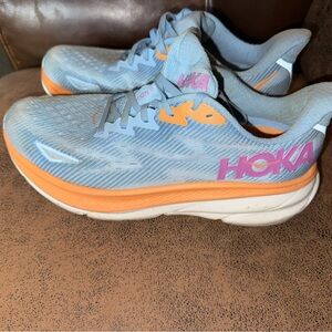 Hoka Women's Light Blue Running Shoes with Orange Accents and Pink Logo